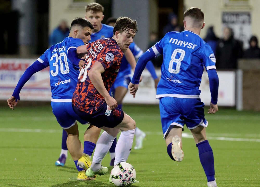 Pacemaker Press 24-3-23
Dungannon v Linfield - Danske Bank Premiership
Linfield's Daniel Finlayson is blocked by Dungannon's Joseph Moore and Ryan Mayse during this evening's game at Stangmore Park, Dungannon.  Photo by David Maginnis/Pacemaker Press